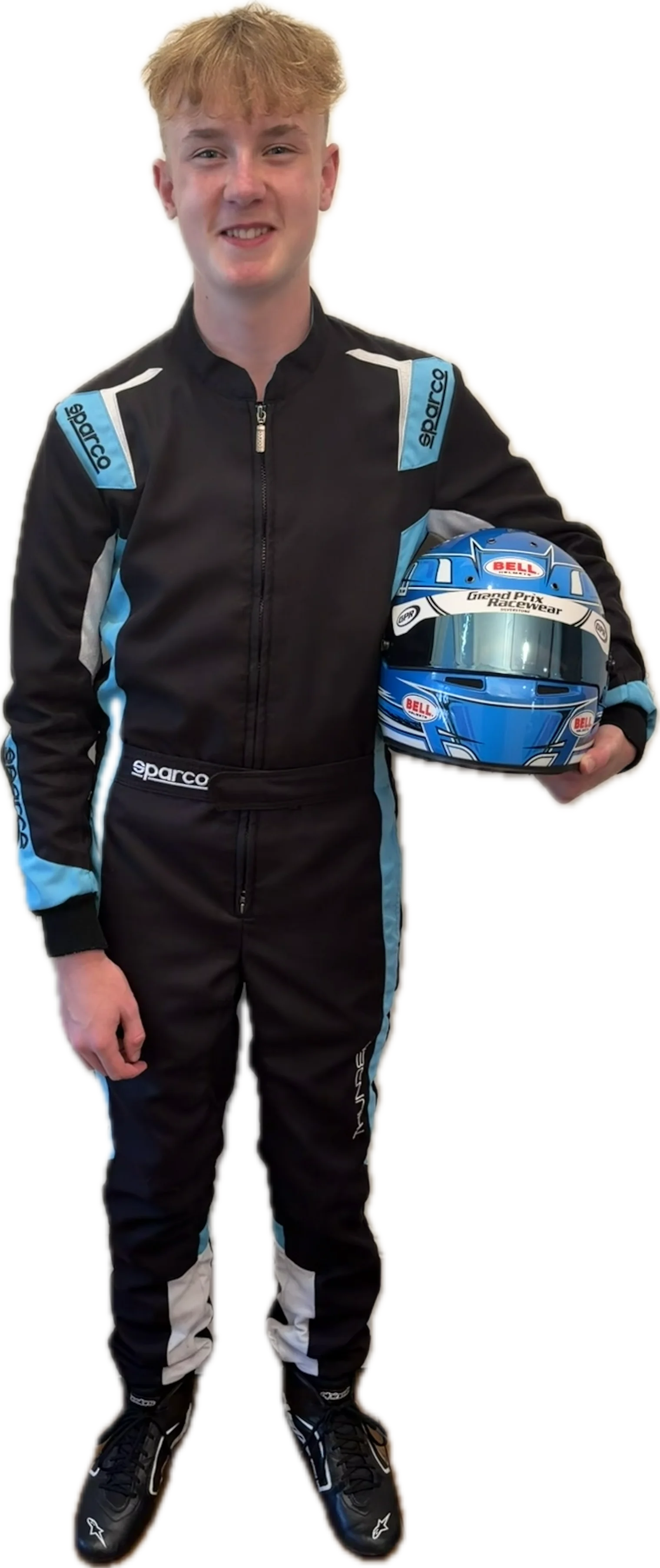 Reuben Tucker in race suit, helmet under his arm